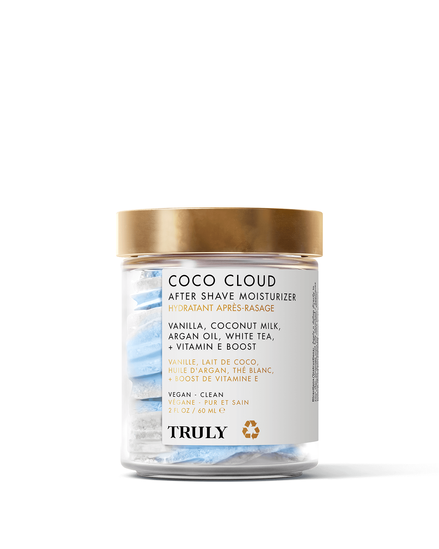 A glass jar with a gold lid contains Coco Cloud After Shave Moisturizer by Truly Beauty, featuring blue and white swirled cream. The label highlights coconut milk, shea butter, vanilla, and argan oil among its nourishing ingredients.