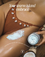 Wearing a brown crochet swimsuit with shell accents, they apply Truly Beautys Coco Cloud After Shave Moisturizer to their thigh. Rich in coconut milk and shea butter, it features creamy coconut and warm vanilla notes. Text reads: Your warm island embrace.