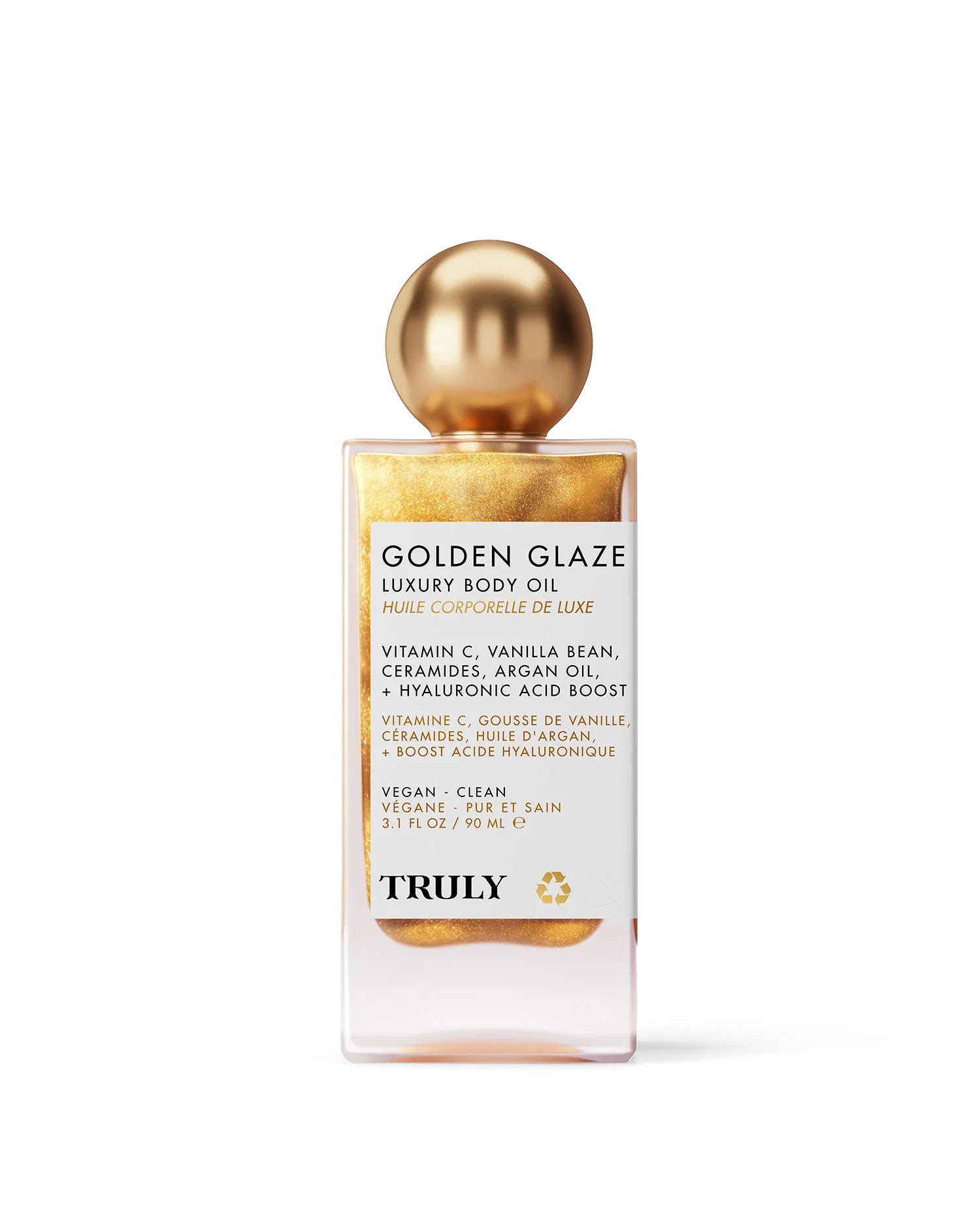 A rectangular bottle of Truly Beauty Golden Glaze Luxury Body Oil with a gold cap. This hydrating oil is golden and shimmery, and features vitamin C, vanilla bean, ceramides, argan oil, and hyaluronic acid.