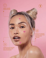 A woman with platinum blonde hair in two buns wears Truly Beautys #Heart Your Imperfections Blemish Patches. Text highlights skincare benefits: they protect against bacteria, prevent picking, and hydrocolloid draws out impurities. Pink background.