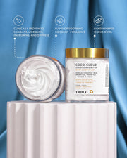Two jars of Truly Beauty’s Coco Cloud Luxury Shave Butter made with coconut milk to help prevent ingrown hairs—one upright showing the label, one on its side revealing the creamy texture. Blue satin background with skincare benefit icons above.