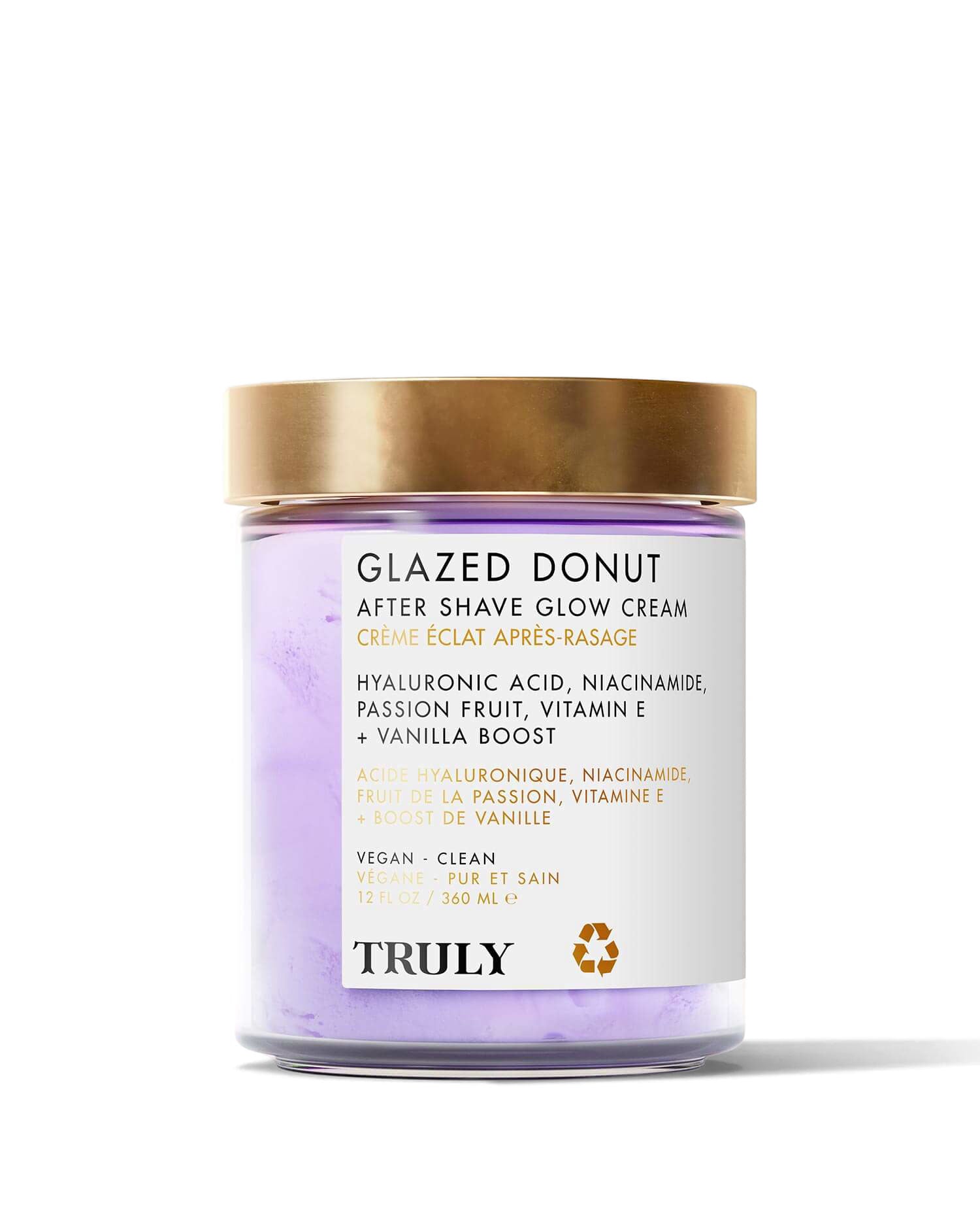 A jar of Truly Beauty Glazed Donut After Shave Glow Cream with a gold lid and purple cream inside, made with niacinamide, vanilla, vitamin E, passion fruit, and hyaluronic acid for radiant, glazed donut-inspired skin.