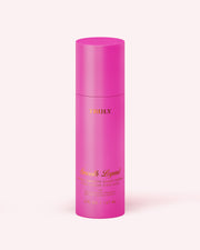 A tall, cylindrical pink bottle labeled Truly Beauty and Hydra-Smooth Shave Cream, with gold text and a matching pink cap, stands upright on a light pink background.