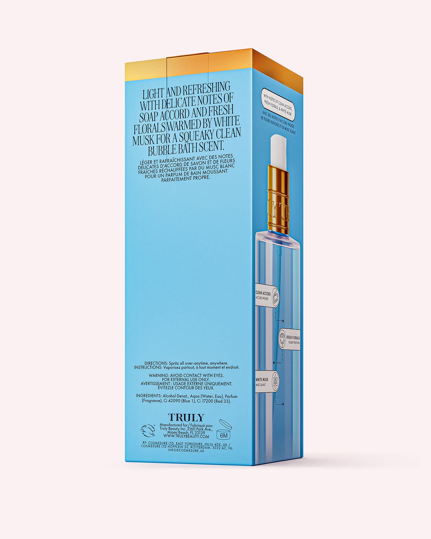 A blue and gold rectangular box for Truly Beautys Clean Girl Perfume Mist features a dropper bottle image, fresh floral and white musk fragrance notes, and brand plus ingredient info at the bottom.