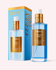 A bottle of Truly Beauty’s Clean Girl Perfume Mist, with blue liquid and gold and white accents, stands beside its box. Both display the product’s name, suggesting a fresh floral scent for an effortlessly chic vibe.