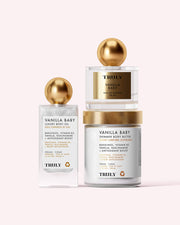 The Vanilla Baby Luxury Trio by Truly Beauty features body oil, shimmer body butter, and perfume—each with gold lids and white labels on a light pink background. Enjoy their warm vanilla scent for glowing, radiant skin all day.