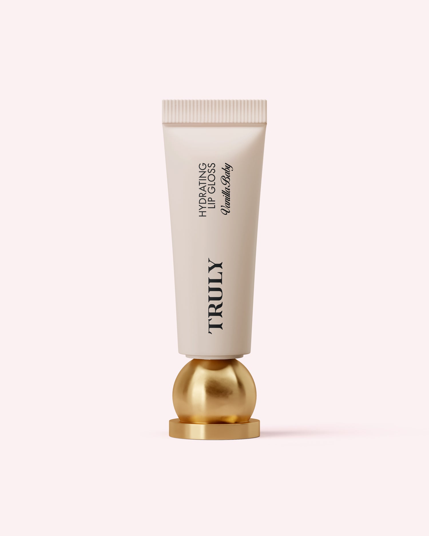 A white tube of Truly Beauty Hydrating Lip Gloss with black text stands upright on a shiny gold sphere against a pale pink background, highlighting its high-shine finish and hydrating hyaluronic acid formula.
