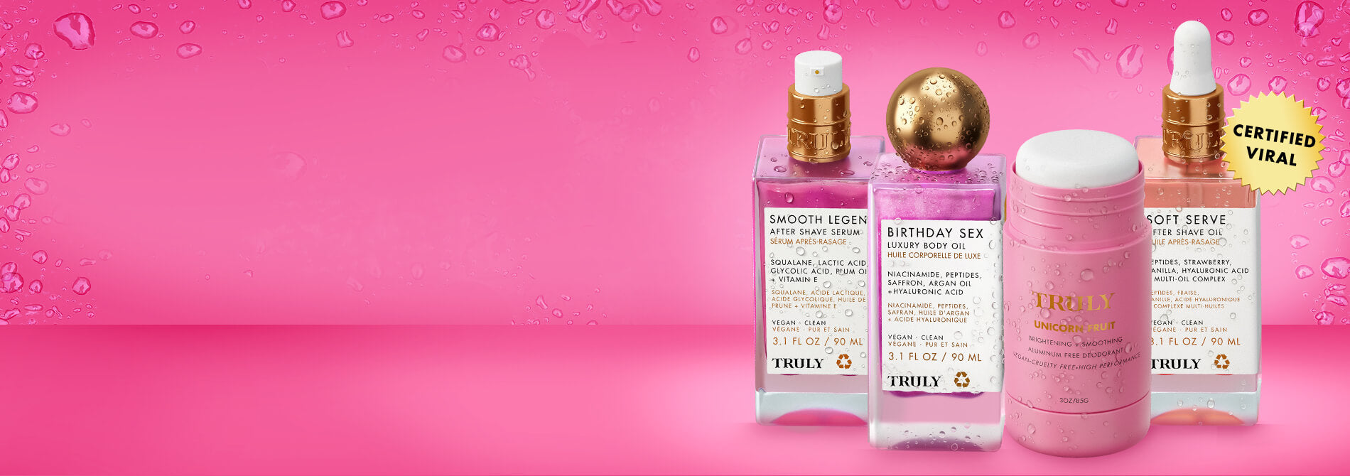 Four Truly Beauty Tiktok Pink Routine products are lined up on a light pink background, featuring three serum bottles with droppers and a round deodorant stick labeled Pineapple Fruit.
