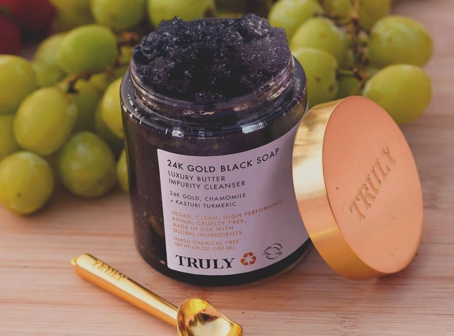 Is Salicylic Acid a BHA | Truly's 24k gold black soap cleanser on table with grapes