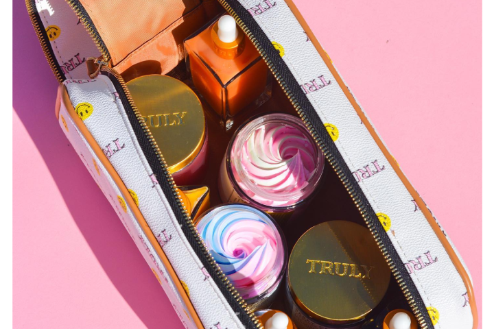 Truly beauty products in white smiley cosmetic bag