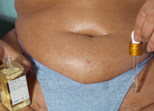 Closeup of Truly's cooka oil being applied to bikini area with dropper