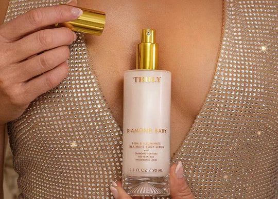 How to get rid of crepey skin treatment | Two side-by-side photos of Truly’s Diamond Baby Body Serum: left shows glass bottle with gold pump and dripping white serum, while right shows  product being applied to a leg for a shimmering glow.