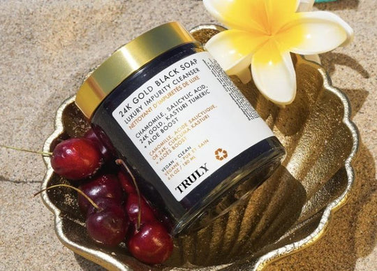 coconut milk benefits for skin | Dark haired woman in bath holding jar of Truly's coco cloud shave butter