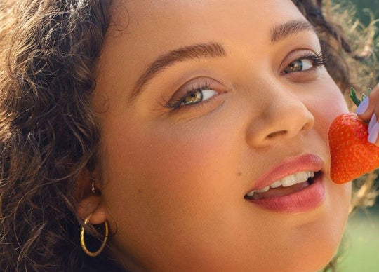 How Poor Nutrition Makes Your Skin Dry | young woman in kitchen pouring green smoothie into glass