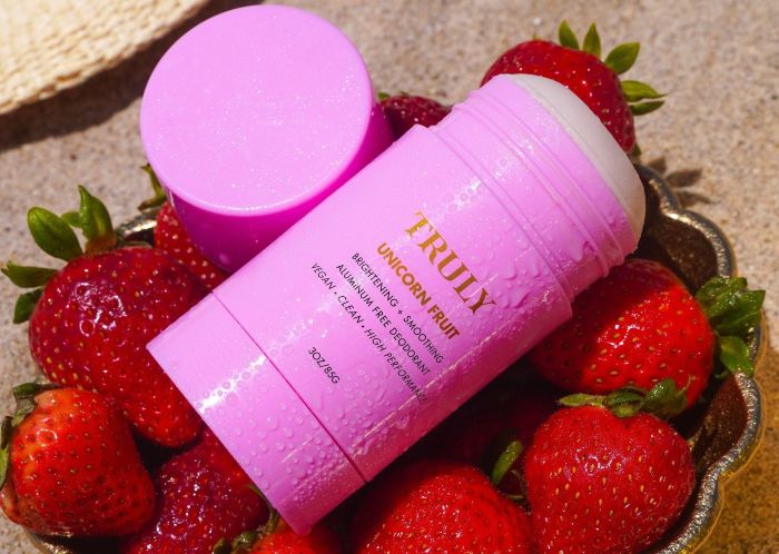 Truly Unicorn fruit aluminum free deodorant on top of bowl of strawberries | best aluminum free deodorant for women