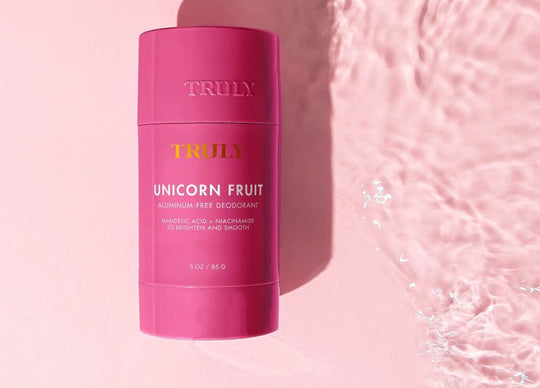 woman's hand in jar of Truly's birthday sex shimmer body butter