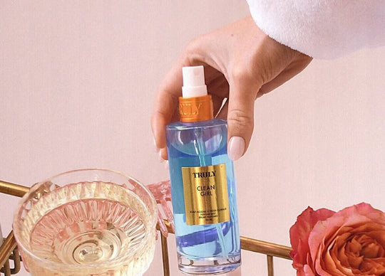 How to Make the Scent of Perfume Last Longer | young woman holding truly's cherry baby perfume in one hand and daisies in the other hand