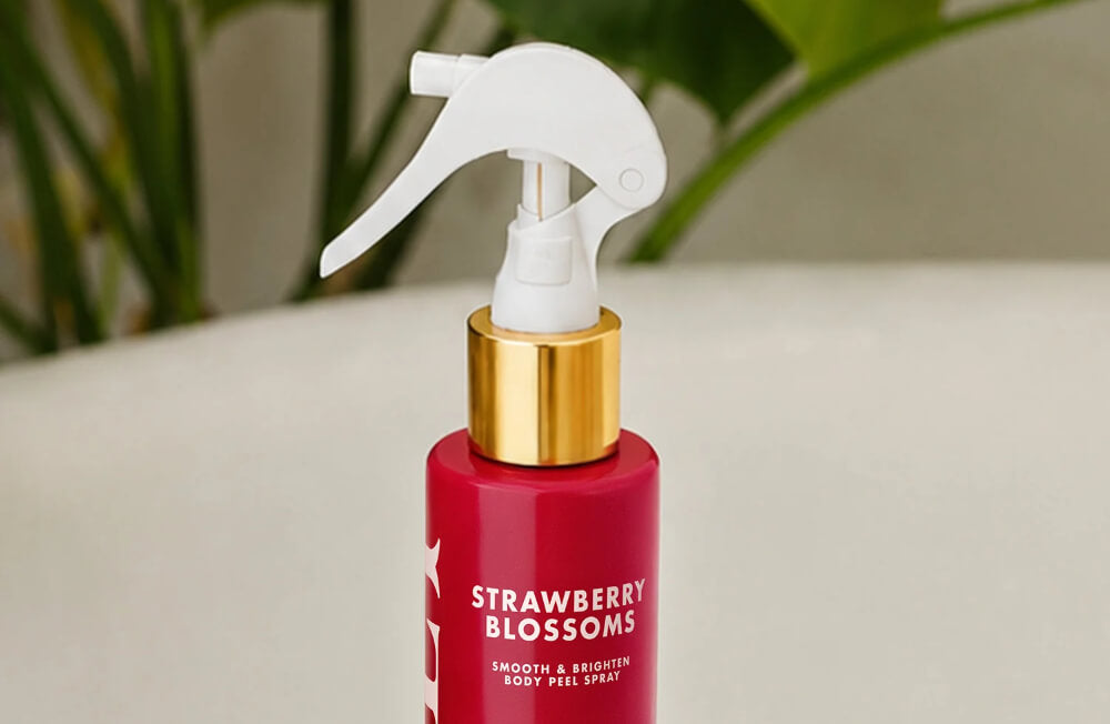 Closeup of a red bottle of Truly Strawberry Blossoms spray, a treatment for strawberry legs
