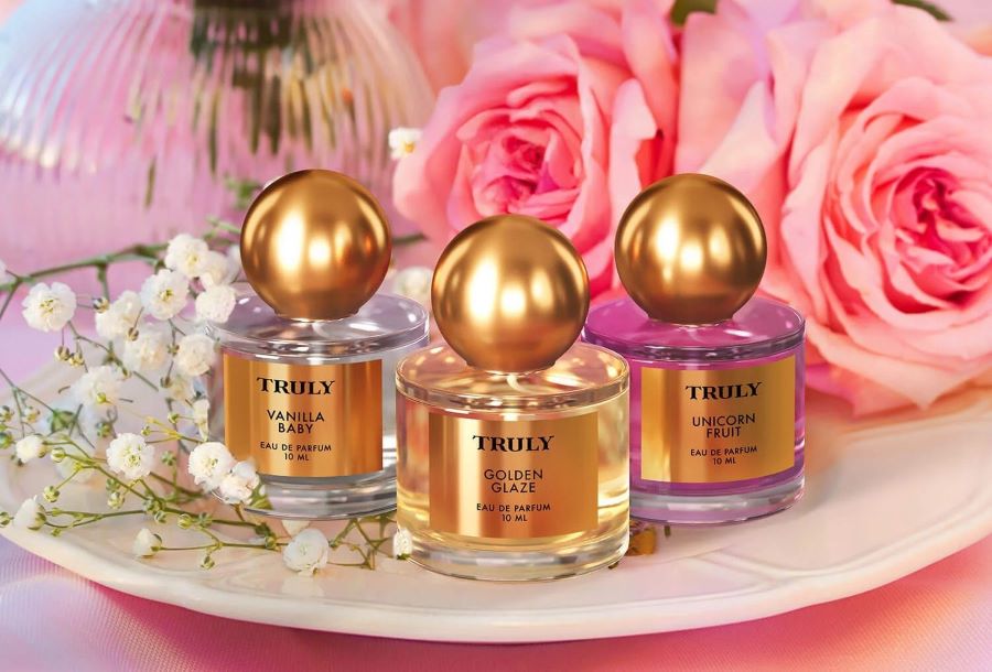 how to make perfume with essential oils | three truly beauty perfumes including vanilla baby, golden glaze, and unicorn fruit perfume on plate with roses