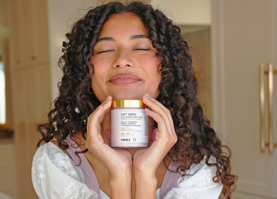 young woman applying Truly's glazed donut serum to face with dropper