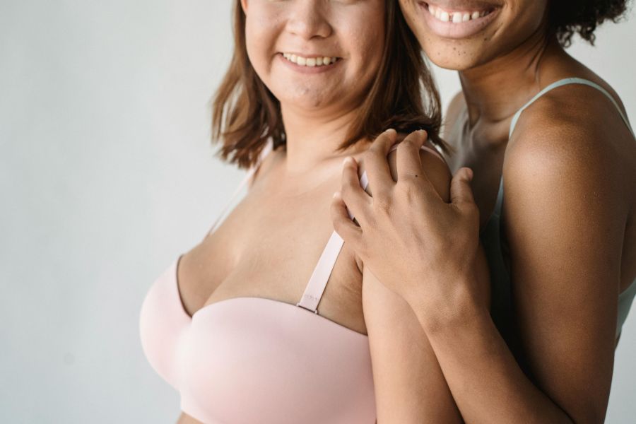 Close-up of Women in Lingerie Hugging | national no bra day benefits of wearing no bra