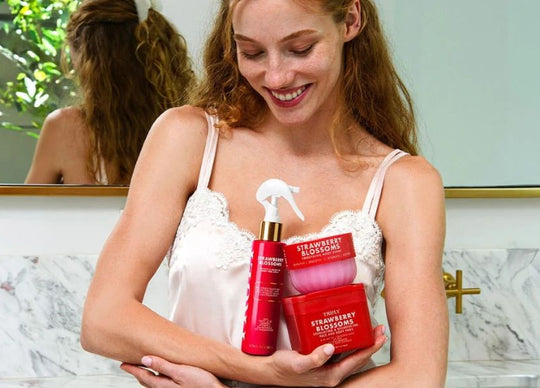 niacinamide and salicylic acid | closeup of woman's hand in jar of Truly's birthday sex body butter