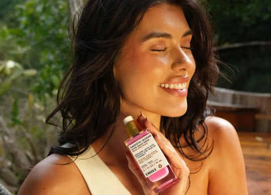 layer skincare products | Young woman with closed eyes holding Soft Serve After Shave Cream in front of her face