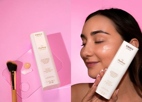 benefits of plum oil for skin | Young woman in pink bathrobe on bed holding Truly's smooth legend serum