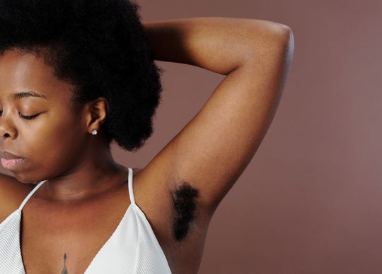 young woman with wet hair holding Truly's shampoo and conditioner