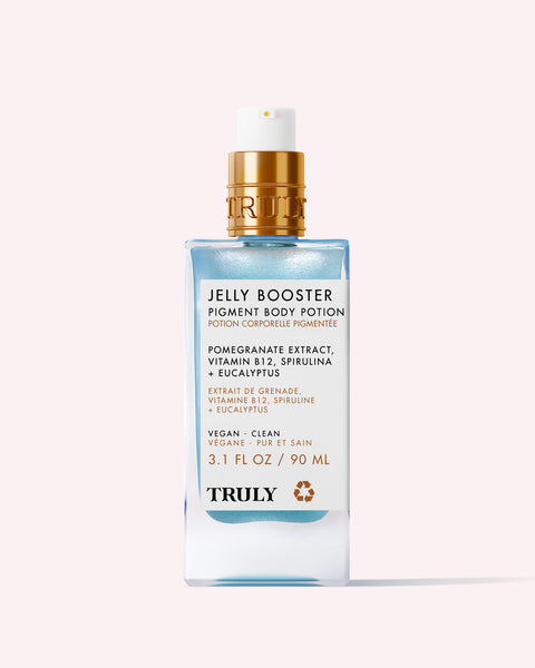 A 90 ml rectangular bottle of Truly Beauty Jelly Booster Pigment Body Potion featuring a gold pump, vibrant blue liquid, and a clear label detailing pomegranate extract serum to help lighten hyperpigmentation and acne scars.