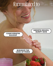 A woman in a bathroom applies a pinkish-beige skincare cream to her upper shoulder with text callouts explaining skin benefits. The image includes the headline 'formulated to' and shows a small container of the product at the bottom left, along with strawberries at the bottom right.