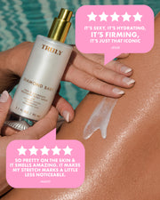 A hand holds a bottle of Truly Beauty’s Diamond Baby Treatment Body Serum beside a leg with its peptide-rich formula applied. Two pink 5-star review bubbles highlight its firming, hydrating, and stretch mark-reducing benefits.
