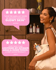 A woman in a white dress stands beside a wooden cabinet holding a small bottle, with two large pink review bubbles overlaid on the left side. The scene appears to promote the skincare bottle rather than show a clean standalone product shot.