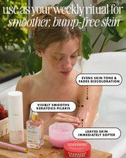 A woman sits in a bathtub surrounded by skincare products, with text callouts describing benefits of the skincare routine. Visible products include a white bottle labeled Tula's, a pink jar, and a red Strawberry Blossoms cream.