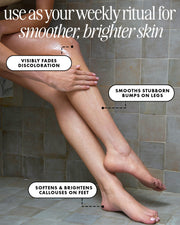 A close-up of a person's legs and feet on a tiled floor with text overlays describing skin benefits, such as fading discoloration, smoothing bumps on legs, and brightening calluses.