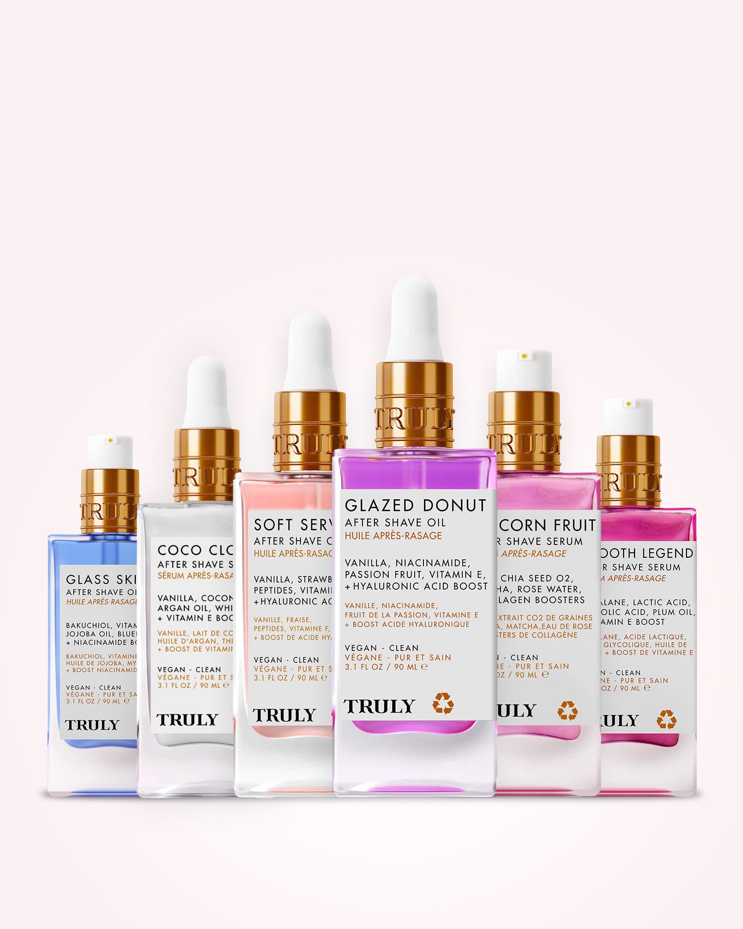 Six pastel-colored bottles from the Truly Beauty After Shave Oils Collection—each with a dropper and labeled with a unique formula—are arranged side by side in shades of blue, white, pink, yellow, lavender, and purple. Don’t miss this Limited-Time Offer to experience Truly Beauty’s signature After Shave Oils for softer, smoother skin.