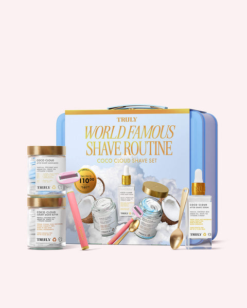 The Truly Beauty Coco Cloud Shave Set features pastel jars of shaving cream and shave butter, a pink-and-yellow 5-blade razor, a dropper bottle, spoon, and coconut-themed packaging labeled World Famous Shave Routine.