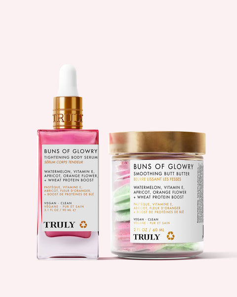 Truly Beauty’s For Your Buns Routine features a pink bottle of tightening serum and a jar of smoothing butter, both designed to improve skin tone and displayed against a light pink background.