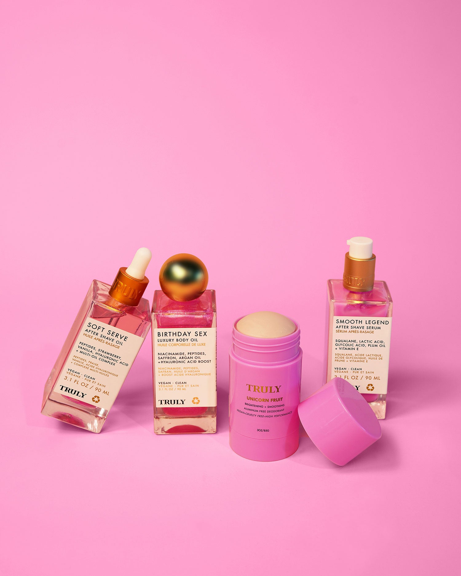 The Tiktok Pink Routine by Truly Beauty is displayed on a pink background, featuring three dropper bottles and a pink stick for the perfect pink skincare set.