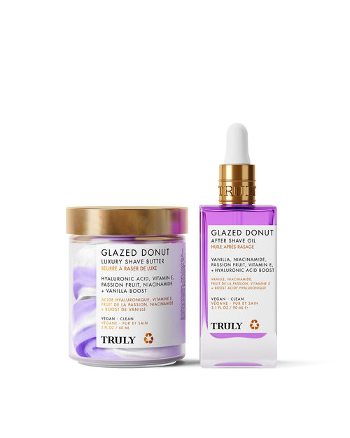 The Glazed Donut Duo by Truly Beauty includes a hydrating Shave Butter in a jar with a gold lid and a Shave Oil in a clear dropper bottle, both with purple and white accents.