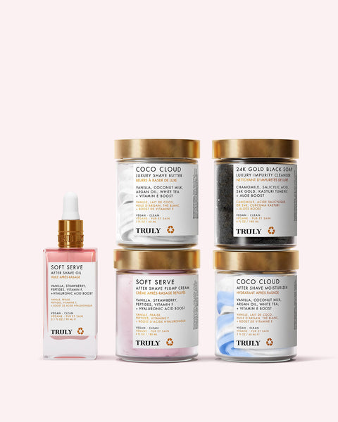 Five skincare products from Truly Beauty’s Gabrielles Ultimate Routine, including a plumping dropper and jars labeled “Soft Serve” and “Coco Cloud,” are arranged side by side against a light pink background for radiant skin.