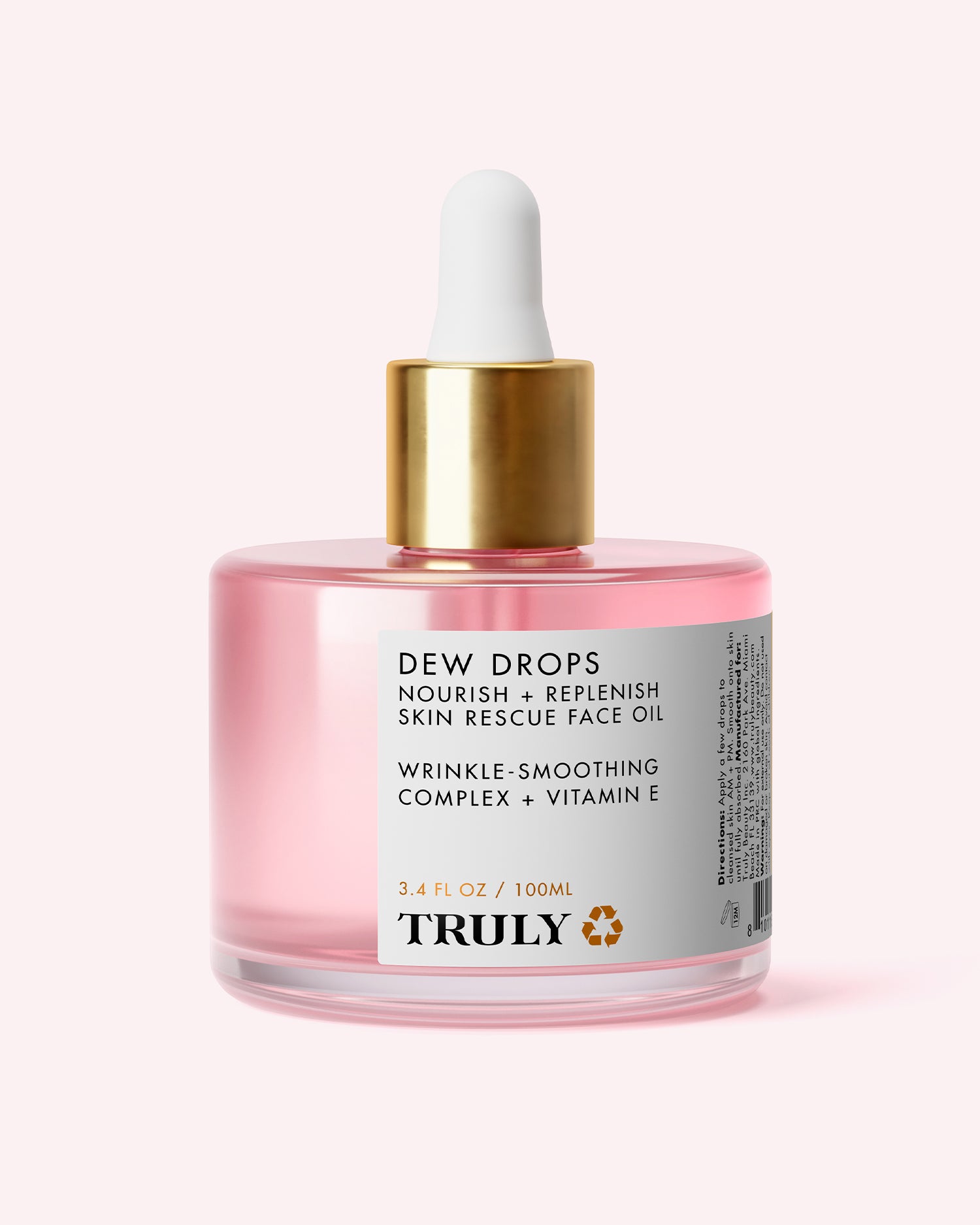 A pink glass dropper bottle labeled Pink Dew Drop Skin Rescue Face Oil, featuring a gold cap, by Truly Beauty. This hydrating facial oil contains 3.4 fl oz (100ml) of a wrinkle-smoothing complex and vitamin E to nourish and replenish your skin.
