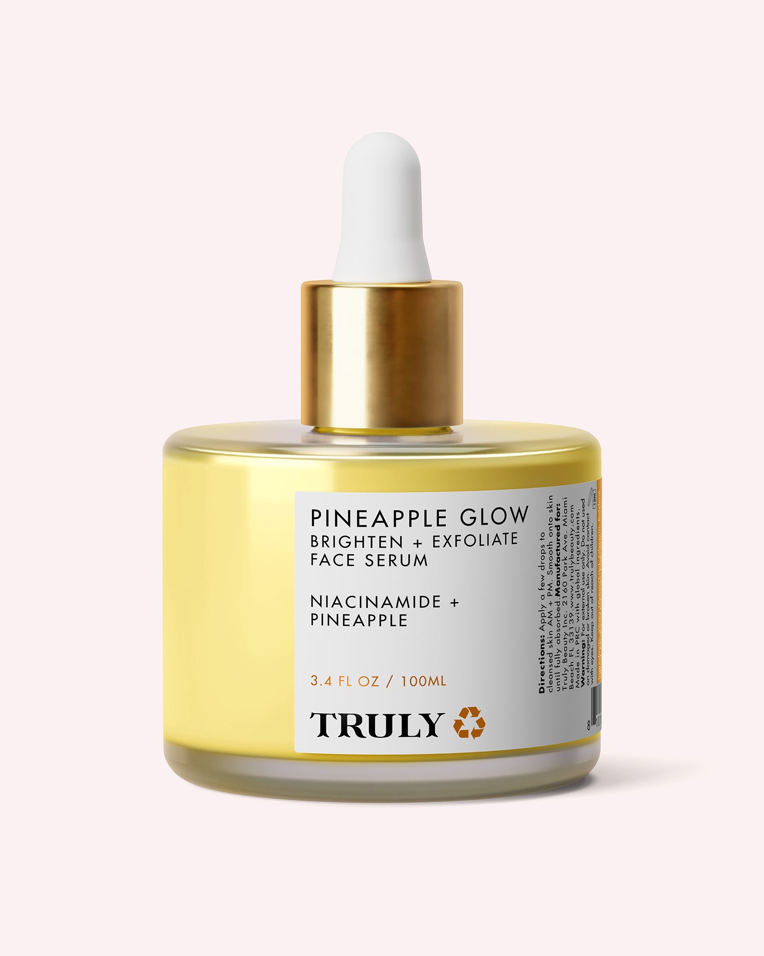 A bottle of Truly Beauty Pineapple Glow Brighten + Exfoliate Face Serum featuring a gold dropper cap, clear yellow liquid, and a white label with black product details, formulated with Pineapple Extract to exfoliate and refine pores for a radiant complexion.
