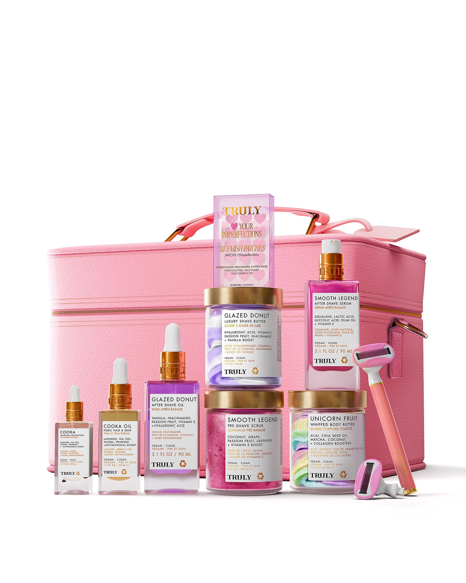 The Smooth Legend Complete Collection by Truly Beauty, featuring serums, creams, and a luxury shave kit with colorful labels and pastel packaging, arranged before a large pink cosmetic case.