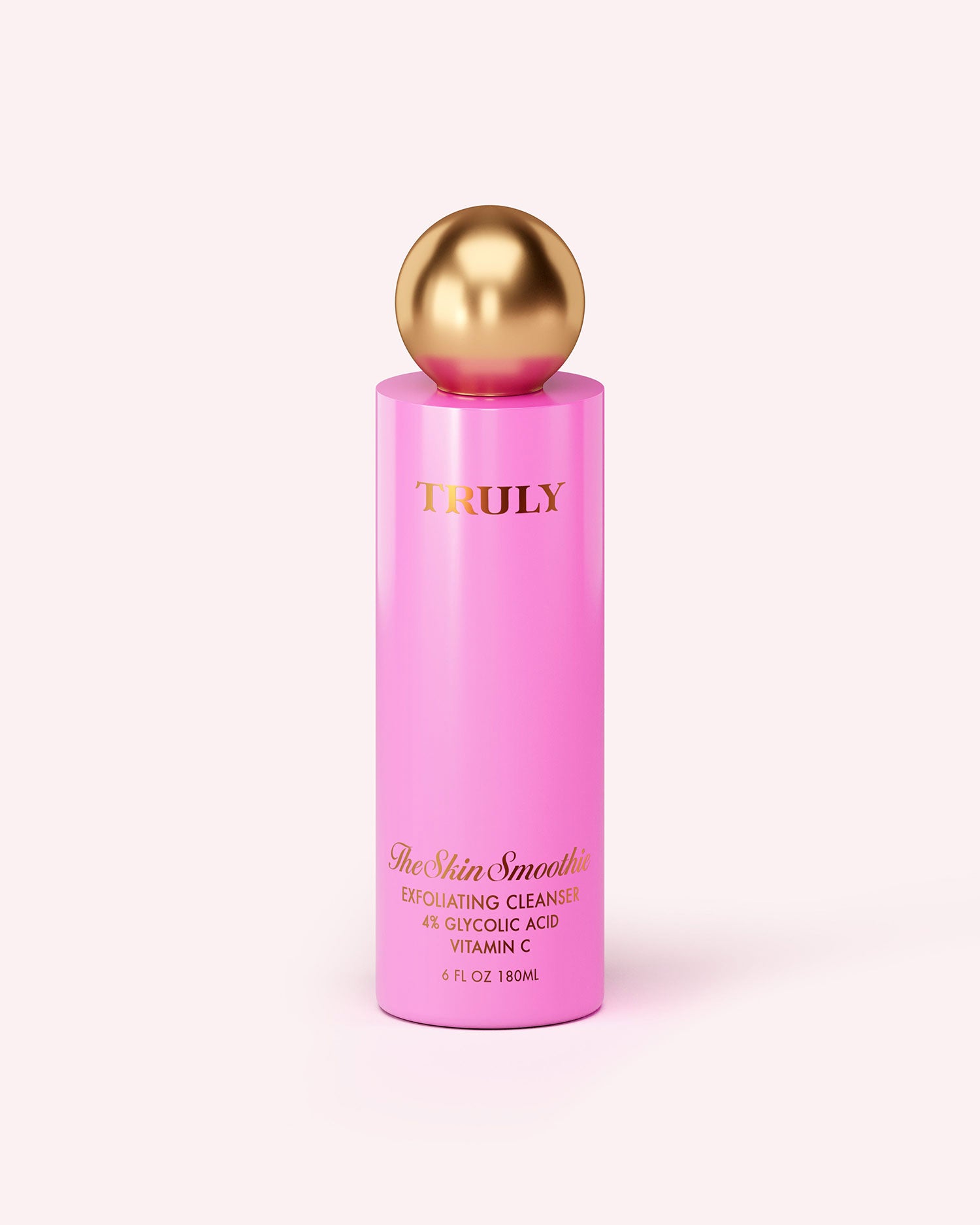 A tall, pink bottle of Truly Beauty Skin Smoothie Gentle Facial Cleanser with a shiny gold spherical cap is displayed on a light background.