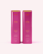 Two identical pink bottles of Truly Beauty's The Smoothing Body Serum (3.1 fl oz/90 ml each) for rough, bumpy skin or keratosis pilaris stand side by side on a light pink background with gold-printed product text and logo.