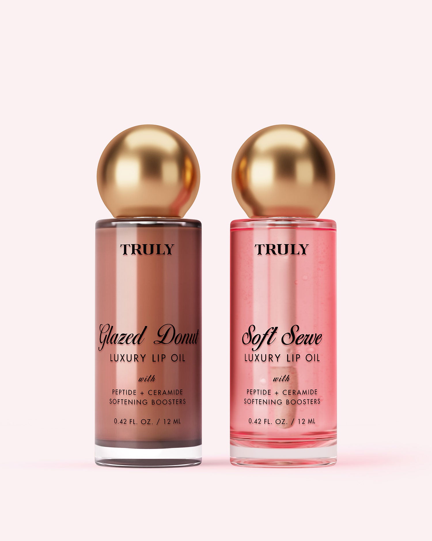 Clear bottle labeled “Truly Beauty Luxury Peptide Lip Oil” with a metallic gold and white applicator wand beside it, set against a light pink background—ideal for those seeking nourishing, hydrating lip care.