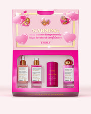 A pink gift box labeled “WARNING: may cause dangerously high levels of confidence” displays Truly Beauty’s The Viral Edit, featuring three brightening skincare products with niacinamide and glycolic acid, and one deodorant, surrounded by heart graphics.