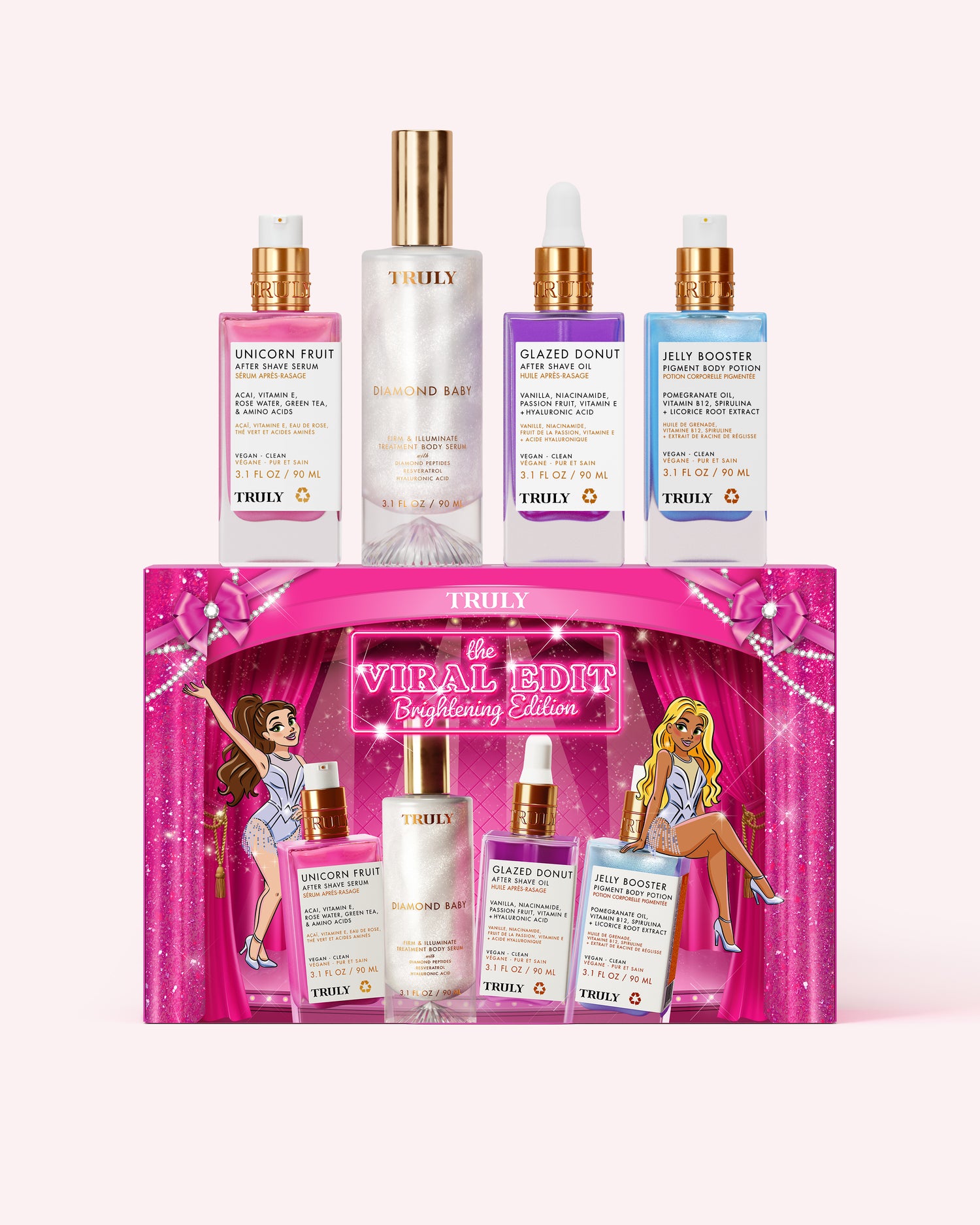 A set of four Truly Beauty skincare bottles displayed above their matching pink gift box. The set includes a pink bottle, a clear bottle with a gold cap, a purple bottle, and a blue bottle, all with gold caps, arranged on a light pink background.