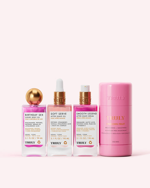 Four Truly Beauty Tiktok Pink Routine products are lined up on a light pink background, featuring three serum bottles with droppers and a round deodorant stick labeled Pineapple Fruit.